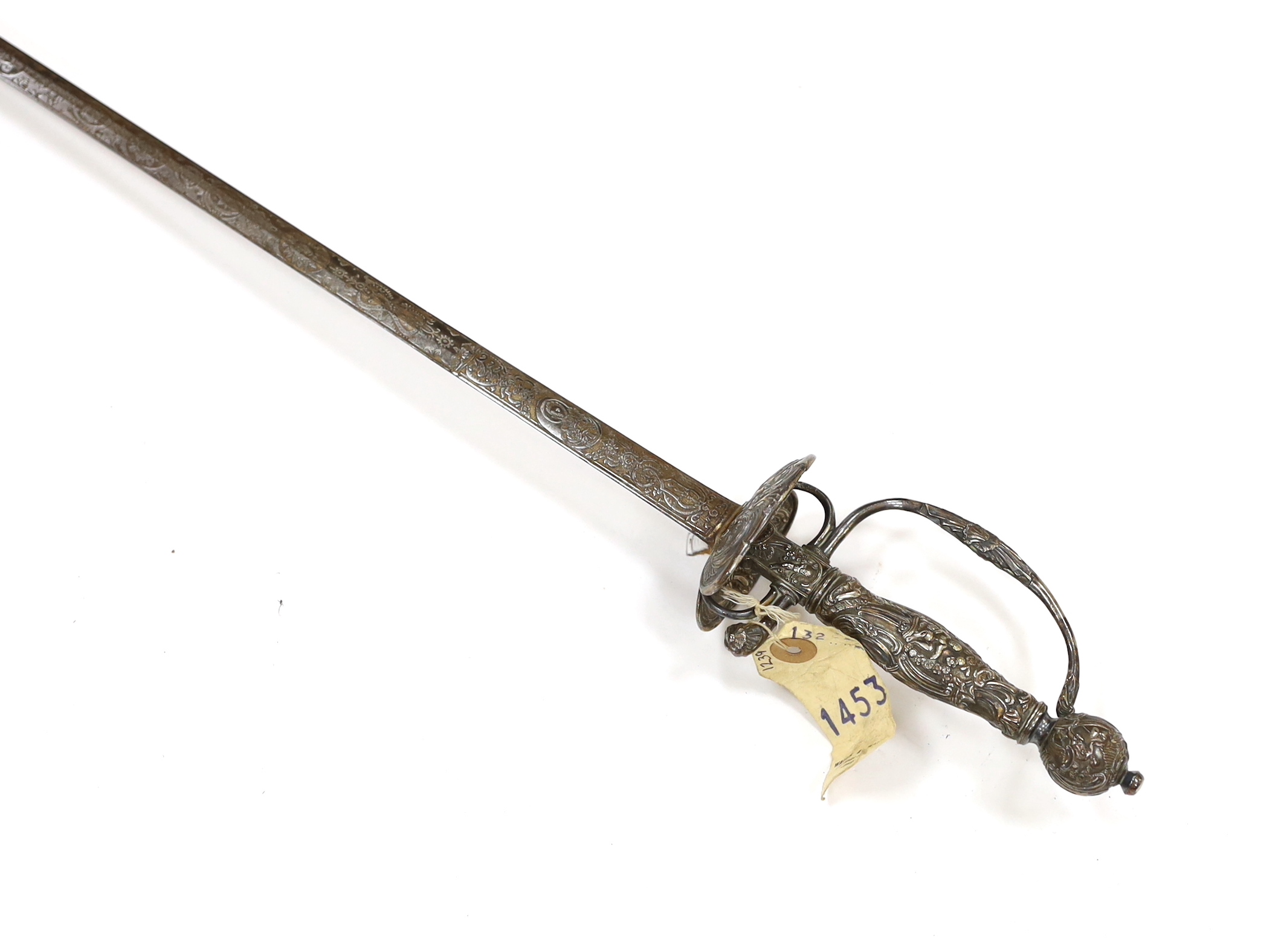 A French silver hilted small sword, c.1770, the guard, pommel and grip all chiselled with putti, flowers and rococo devices, blade etched with commensurate designs with retaining traces of gilding, blade 74cm